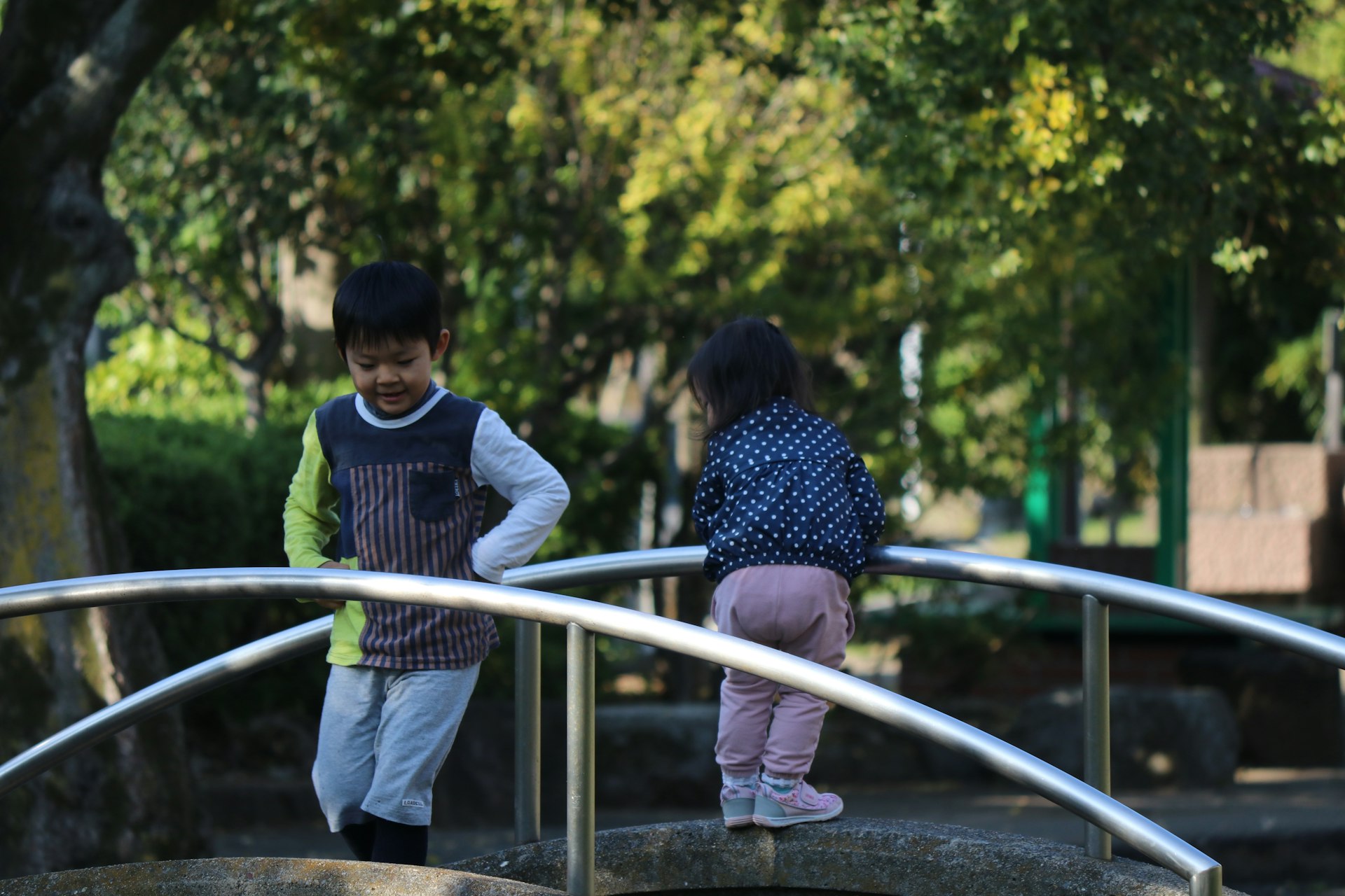 man in black and white long sleeve shirt standing beside woman in blue and white floral